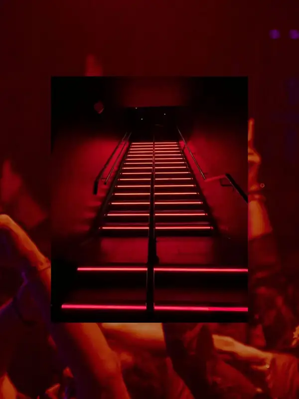 Red-lit staircase inside Coda Toronto