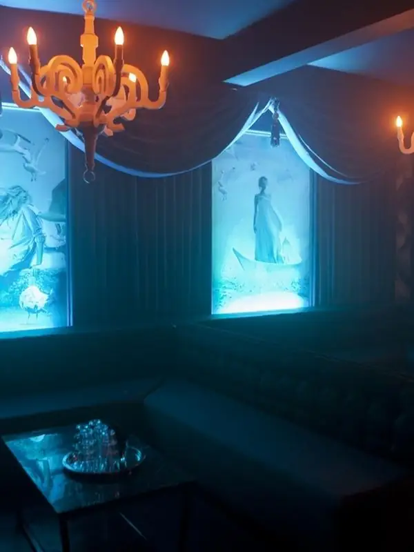 Lounge booths and chandelier inside Fiction nightclub on Pearl Street