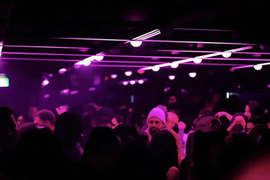 Crowd under purple lights at Infinity Room, below Future on Queen Street West