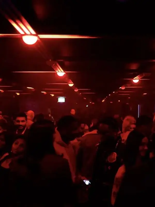 Crowd under red light at Infinity Room Toronto