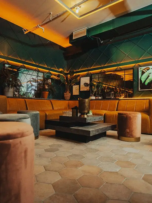 Green lounge with leather sofas at Isabelle's on King Street West